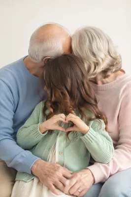 Loving Grandparents Embracing Grandchild Heart Hands