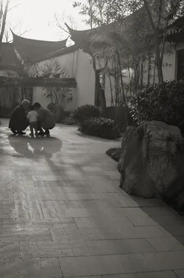 Grandparents and Grandchild in Quiet Courtyard