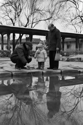 Grandparents and Grandchild by Winter Pond
