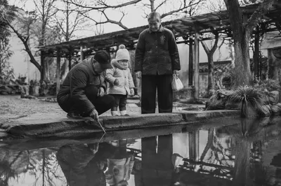 Grandparents and Grandchild by Winter Pond