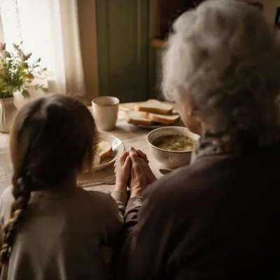 Grandmother Teaching Child Prayer at Dinner