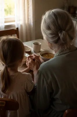 Grandmother Teaching Child Prayer at Table