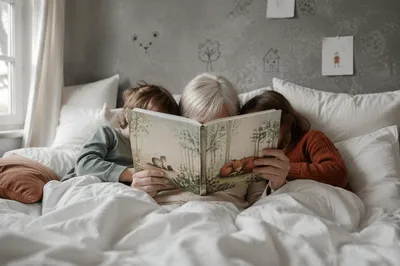 Grandparents and Grandchildren Reading in Bed