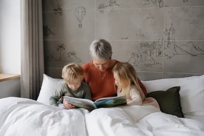 Grandparents Reading With Grandchildren in Bed