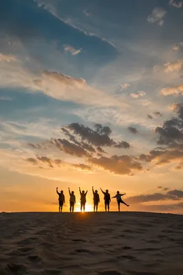 Friends Celebrating Sunset Selfie on Sandy Dune