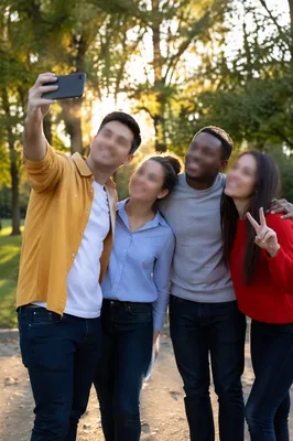 Playful Friends Taking Selfie in Park
