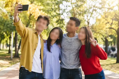 Playful Friends Group Selfie in Park