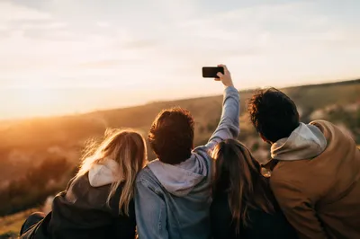 Joyful Friends Selfie on Golden Hillside