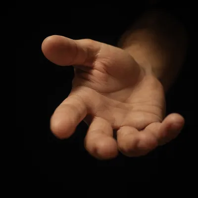 Close-Up Hand Reaching in Darkness