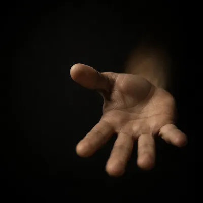 Reaching Hand Close Up in Darkness