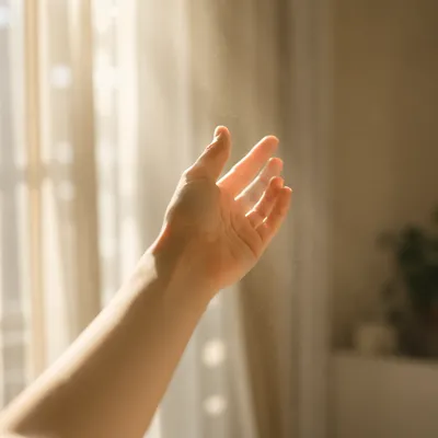 Hopeful Hand Reaching Into Morning Light