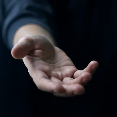 Outstretched Hand Reaching in Quiet Light