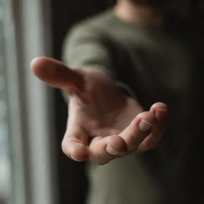 Gentle Hand Reaching Toward the Camera