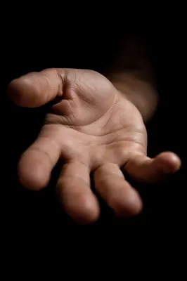 Reaching Hand in Dramatic Dark Close-Up