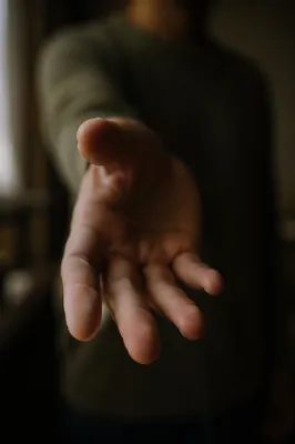 Gentle Hand Reaching Toward Camera