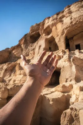Outstretched Hand Reaching Toward Desert Light