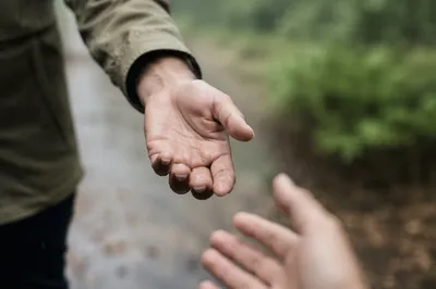Helping Hand Reaching on Rainy Path