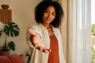 Young Woman Reaching Hand Toward Camera
