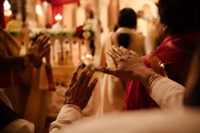 Hands Reaching Forward in Warm Hall
