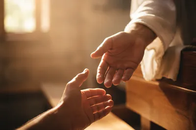 Compassionate Hands Reaching in Chapel Light