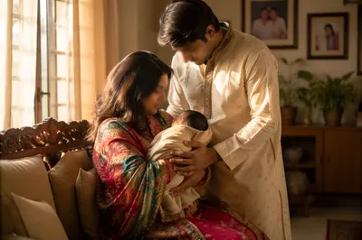 Happy Family Cradling Newborn in Cozy Living Room
