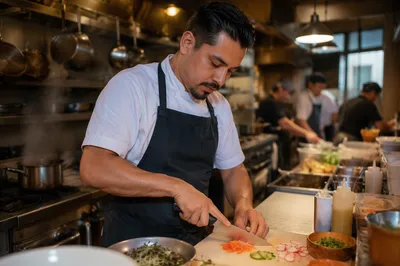 Hispanic Chef Slicing Vegetables in Kitchen
