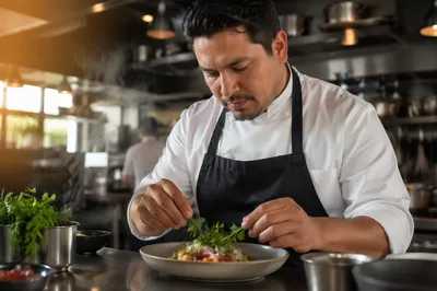 Hispanic Chef Plating Dish in Kitchen