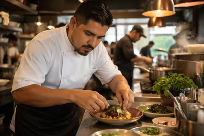 Hispanic Chef Plating Dish in Kitchen