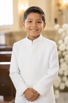 Smiling Child in White Ceremony Outfit