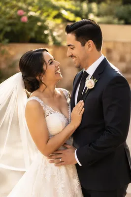 Joyful Hispanic Wedding Couple in Garden