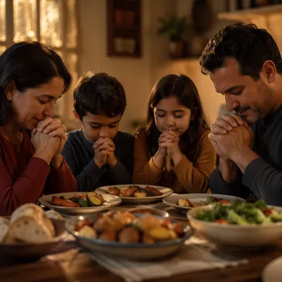 Hispanic Family Praying at Dinner Table