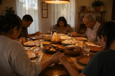 Hispanic Family Praying Before Dinner Together