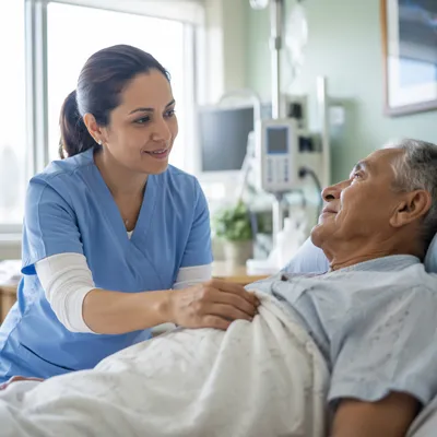 Nurse Comforting Elderly Patient at Bedside