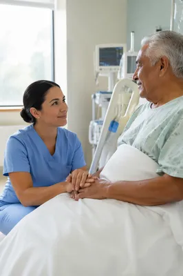 Compassionate Nurse Holding Elderly Patient Hand