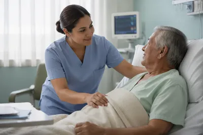 Compassionate Nurse Assisting Elderly Patient