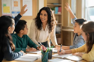 Teacher Guiding Students in Bright Classroom