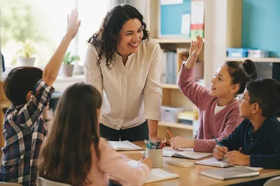 Hispanic Teacher Guiding Students in Classroom
