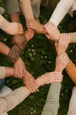 Diverse Hands Forming Circle on Grass