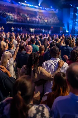 Diverse Congregation in Blue Lit Auditorium