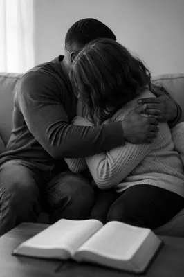 Interracial Couple Embracing During Home Bible Study