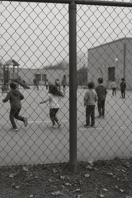 Children Playing Behind School Playground Fence