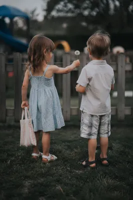Children Sharing Dandelion on School Playground
