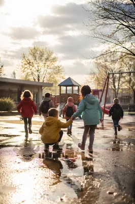Children Sharing Joy on Rainy Playground