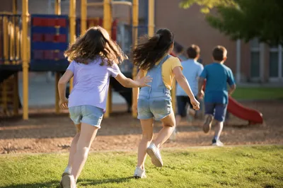 Children Playing on Sunny School Playground