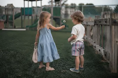 Children Sharing Dandelion on School Playground