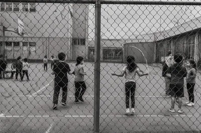 Children Playing Behind School Playground Fence