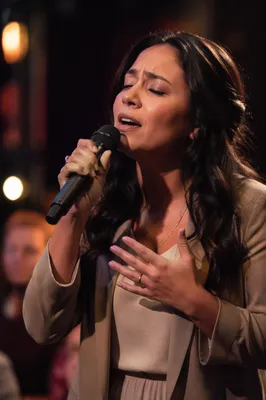 Passionate Female Singer on Warm Lit Stage