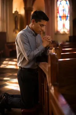 Young Man Praying at Church Pew