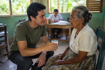 Young Man Helping Elderly Woman Indoors