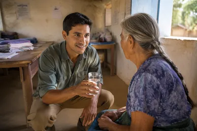 Young Man Caring for Elderly Woman